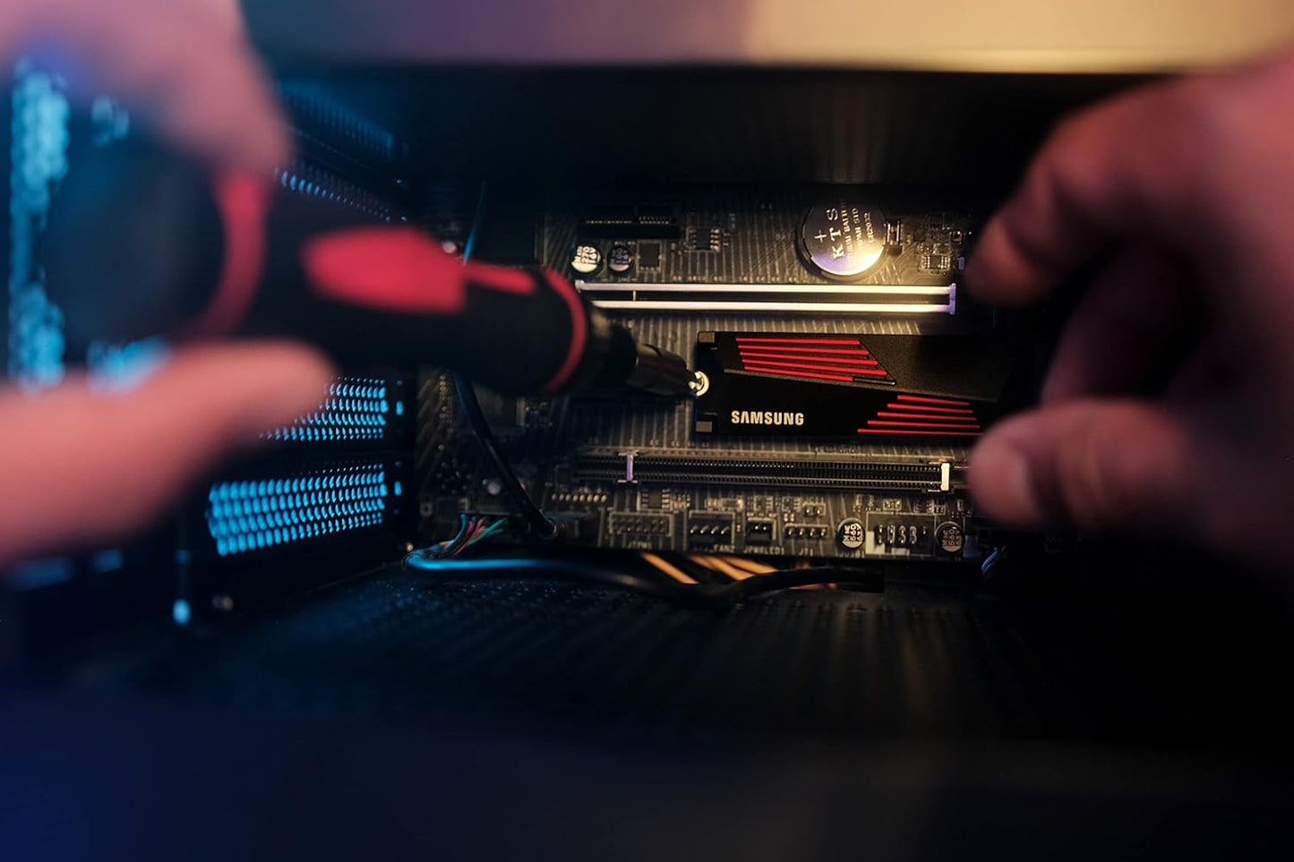 Samsung 990 PRO 1TB NVMe PCIe 4.0 SSD with Heatsink — heatsink drive being screwed into an M.2 slot