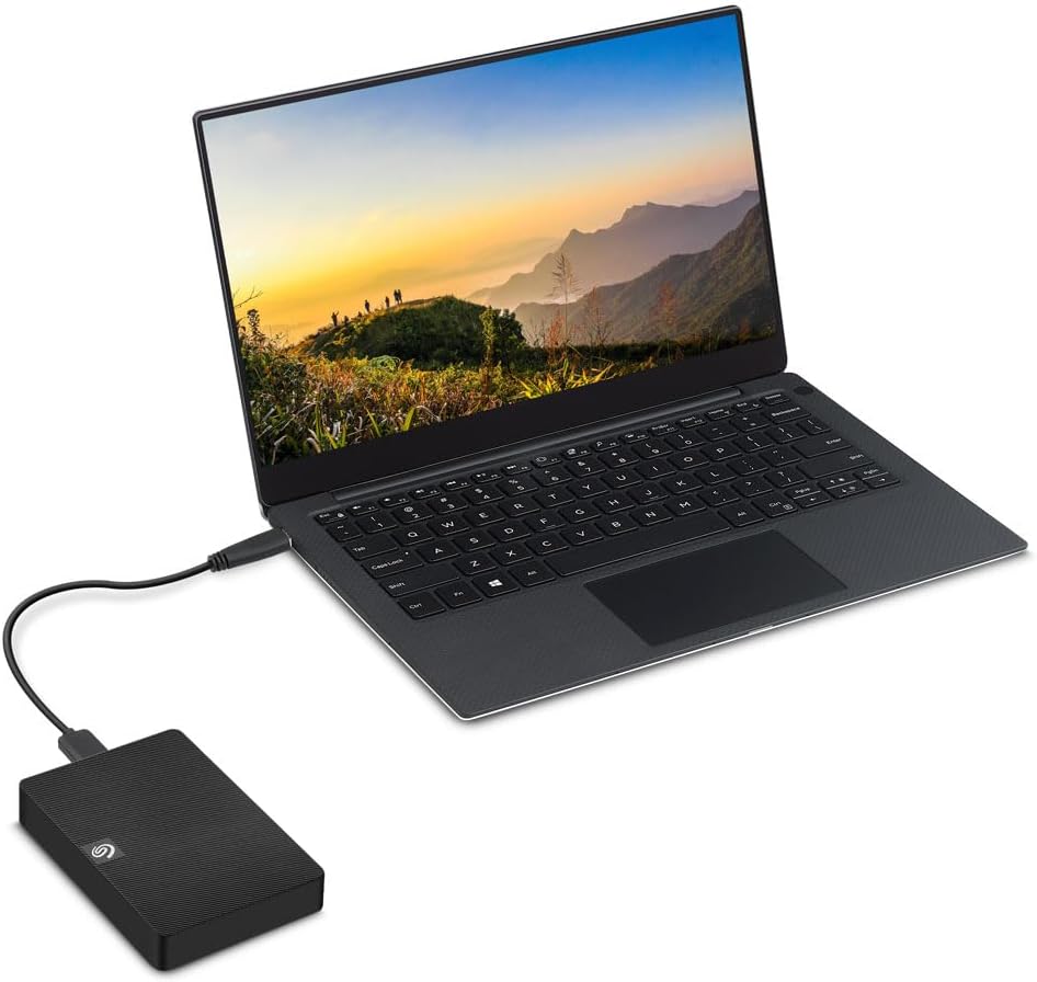 Seagate Expansion 2TB USB 3.0 Portable External Hard Drive — connected to a laptop