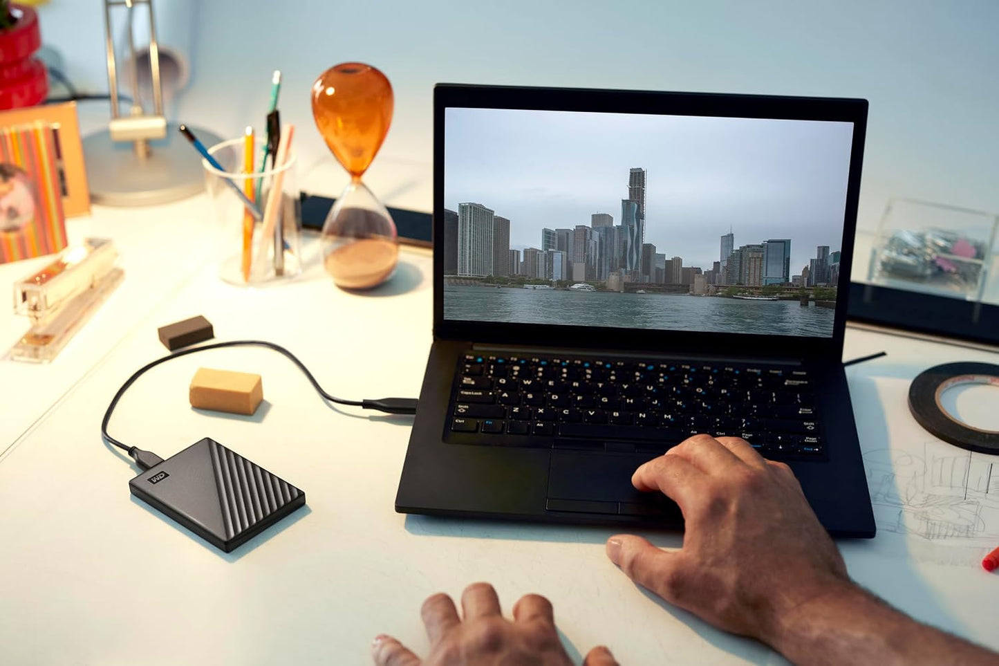 WD My Passport 2TB Portable Hard Drive (Black) — connected to a laptop on a desk