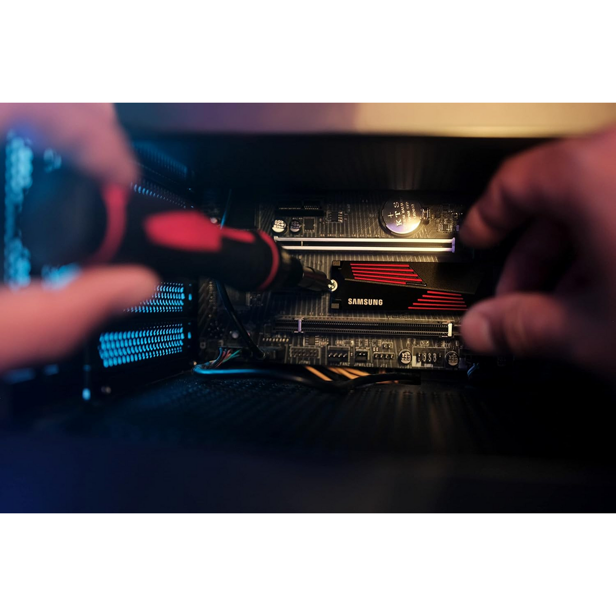 Samsung 990 PRO 1TB NVMe PCIe 4.0 SSD with Heatsink — heatsink drive being screwed into an M.2 slot