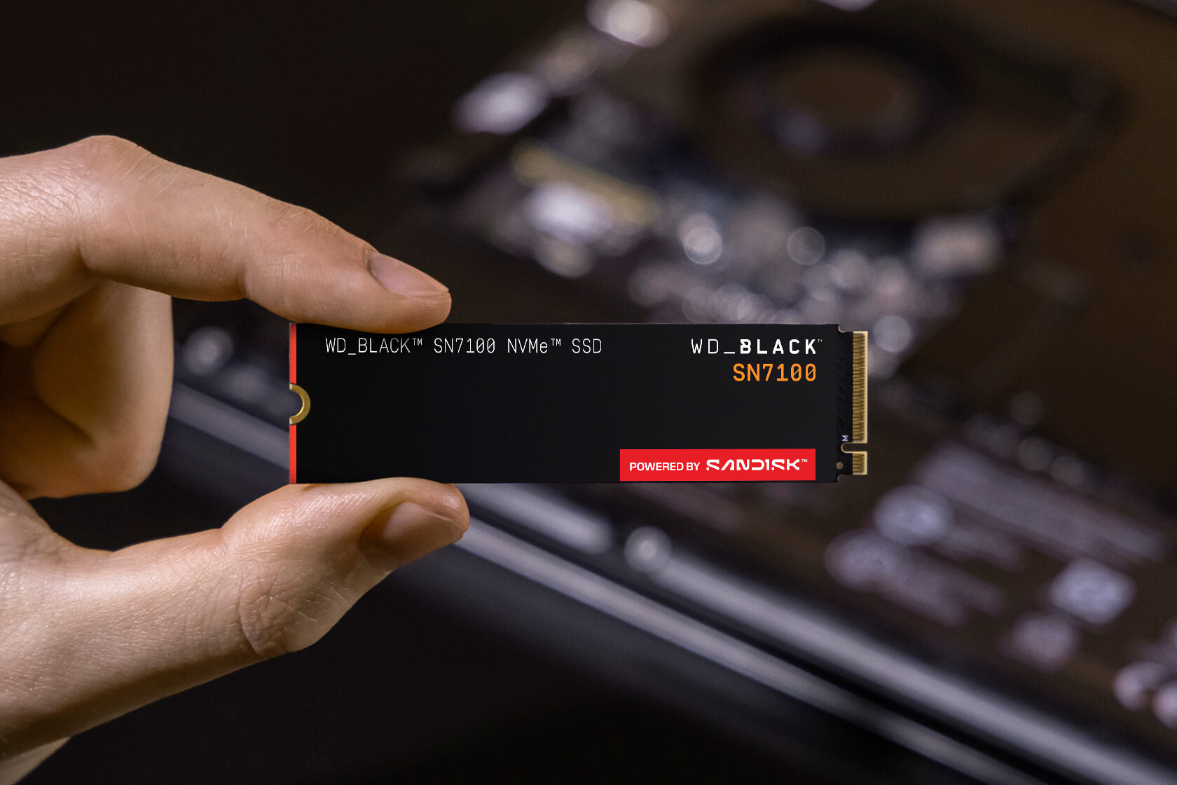 WD_BLACK SN7100 1TB NVMe SSD — held in hand for scale