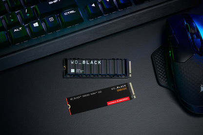 WD_BLACK SN850X 1TB NVMe SSD — shown on a gaming desk alongside the heatsink model