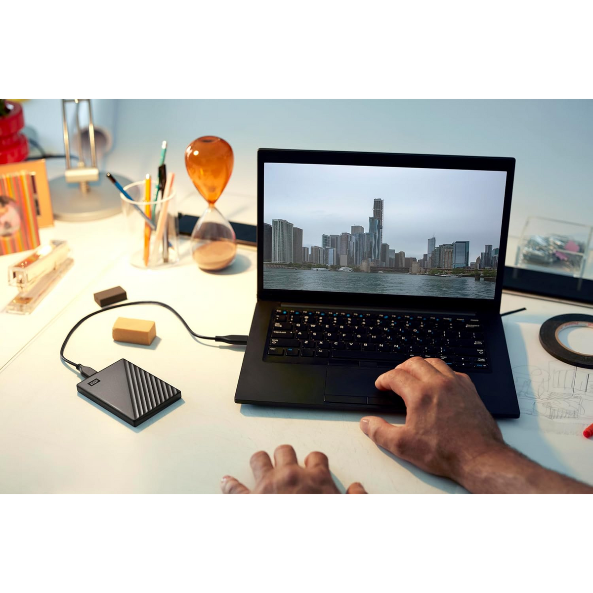 WD My Passport 2TB Portable Hard Drive (Black) — connected to a laptop on a desk